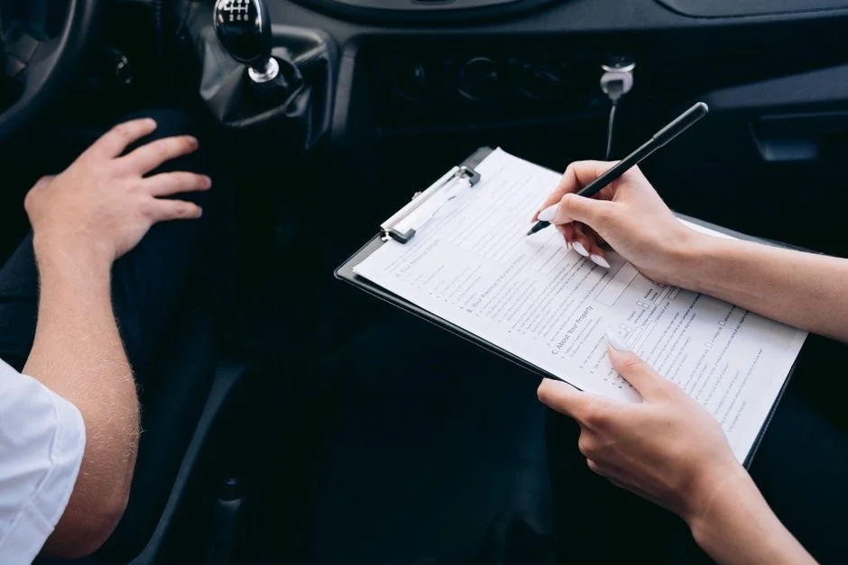 A driver holding keys and insurance documents